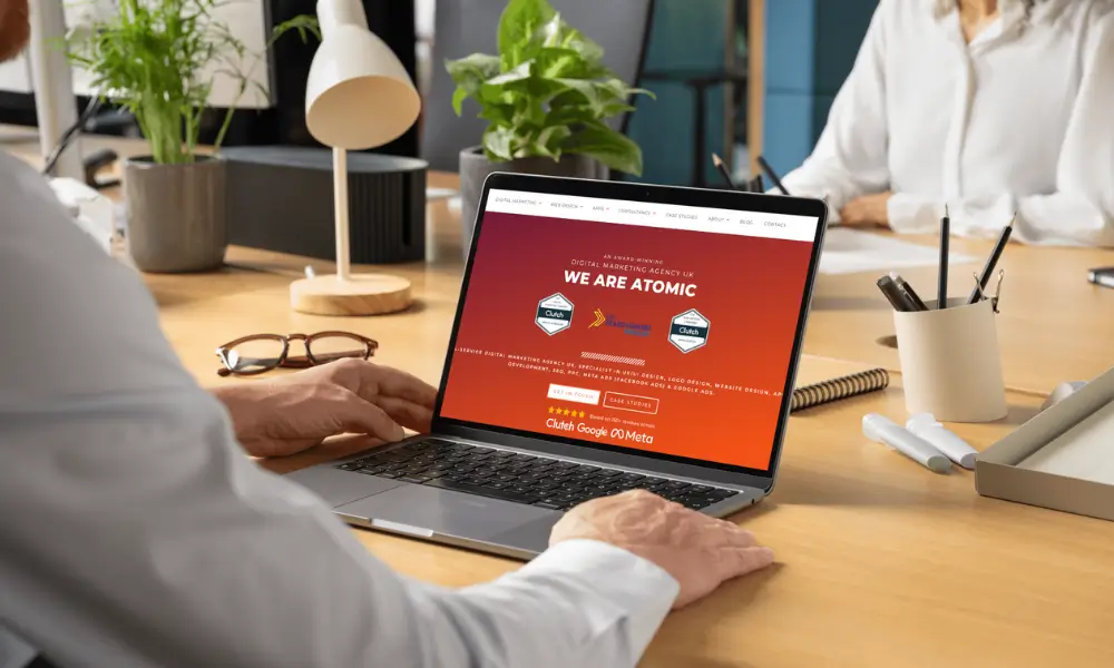 User browsing the Atomic Digital Marketing website on a laptop, highlighting social proof in digital marketing