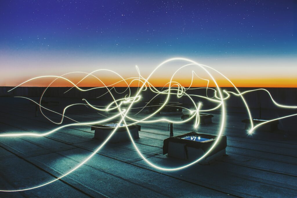 links of light on a rooftop at sunset