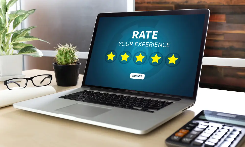 Laptop screen showing a five-star review form, symbolising social proof and online trust