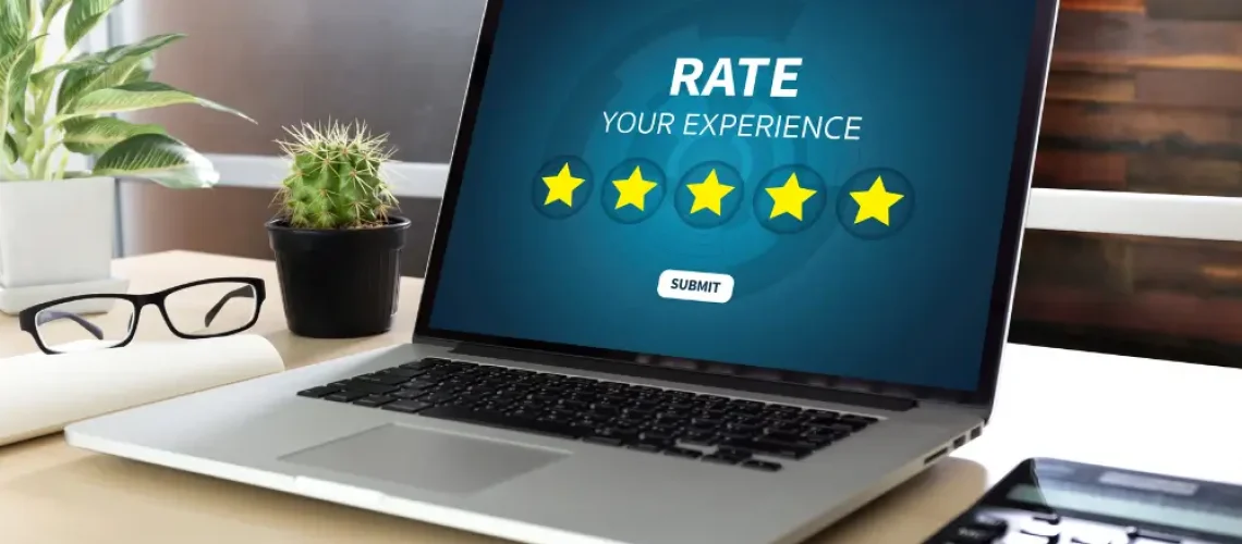 Laptop screen showing a five-star review form, symbolising social proof and online trust