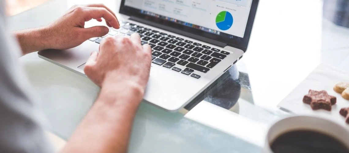 image of a desk with a laptop and coffee on it