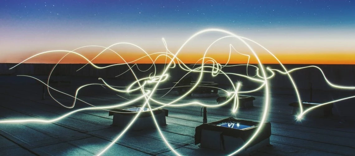 links of light on a rooftop at sunset