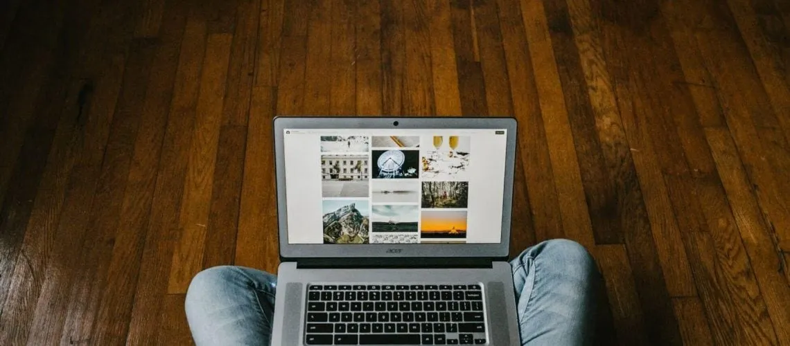 What is Paid Search? Person sitting on Laptop on Wooden Floor